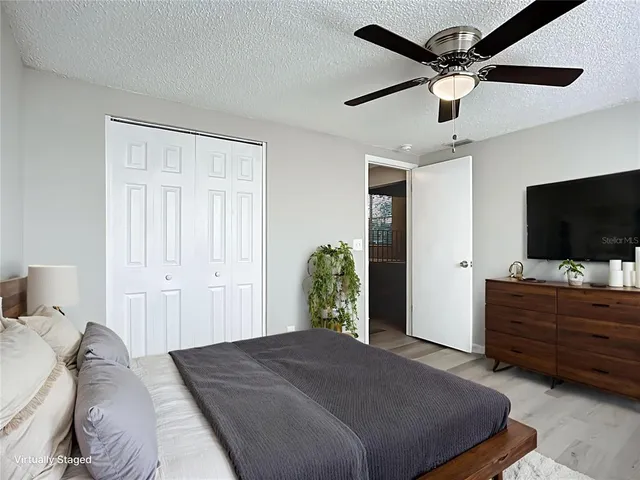 a bedroom with a bed and a flat screen tv