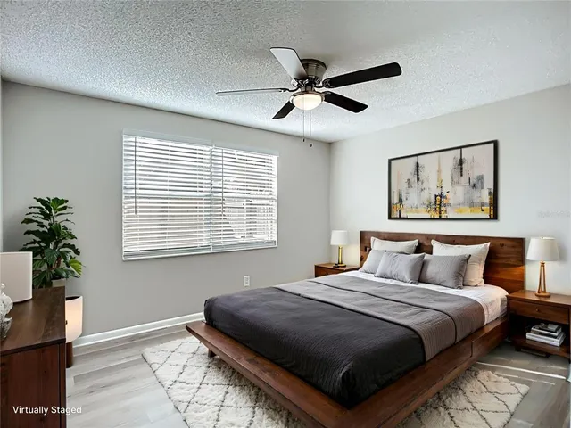 a bedroom with a large bed and a window