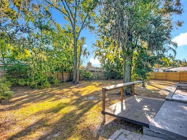 a view of a backyard with sitting area