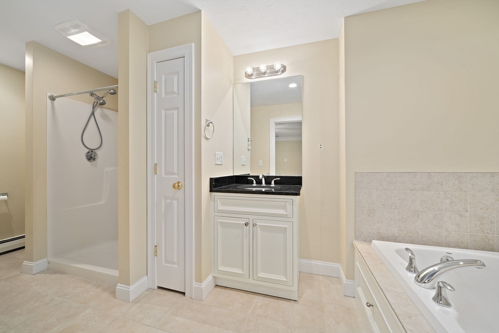 14 Sugar Maple Circle, Unit 14 Hanover, MA 02339 - Photo 18 of 38 a bathroom with a bathtub and a window