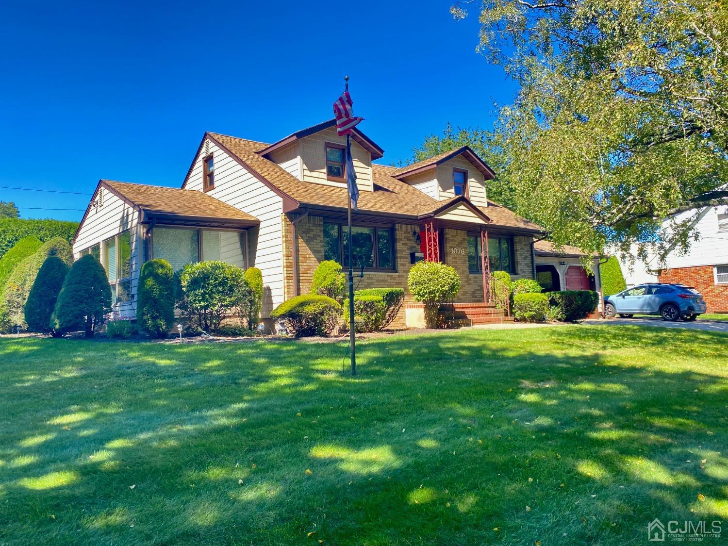 a front view of house with yard and green space