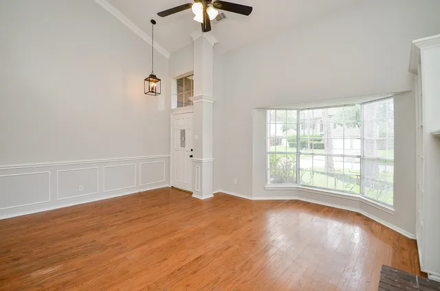 wooden floor in an empty room with a window