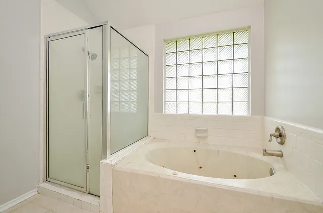 a bathroom with a bathtub and shower