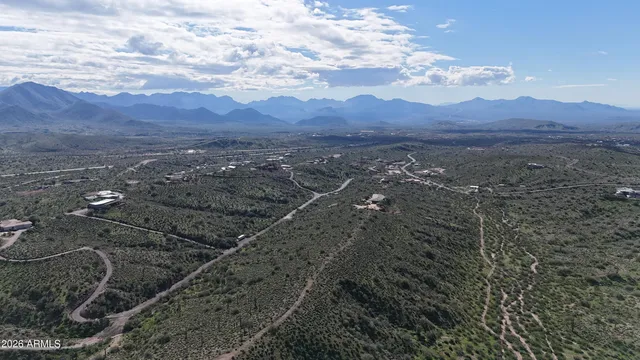 a view of a lush green hillside and houses