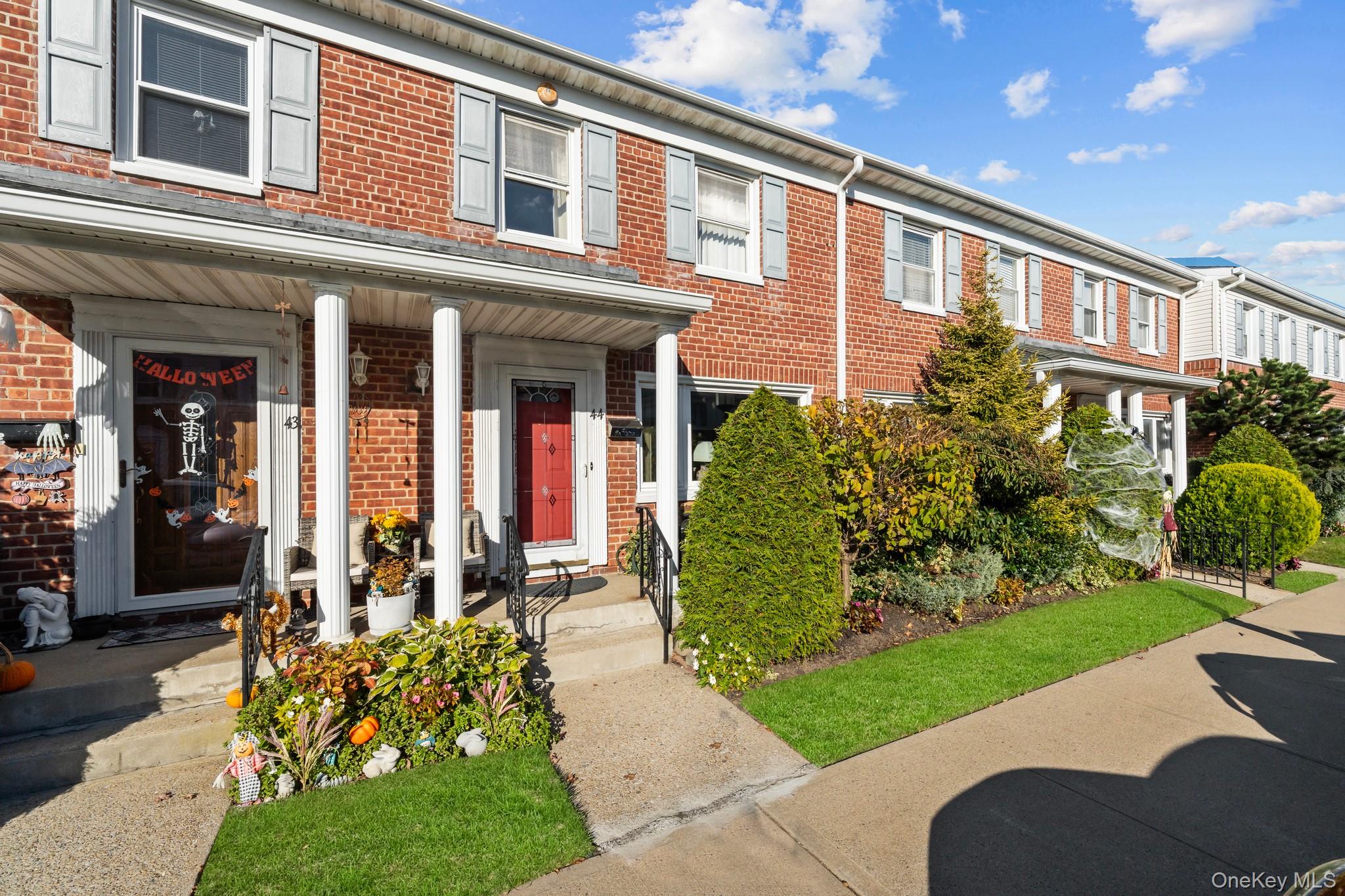 3530 Long Beach Road, Unit 44 Oceanside, NY 11572 - Photo 1 of 17 a front view of a house with a yard