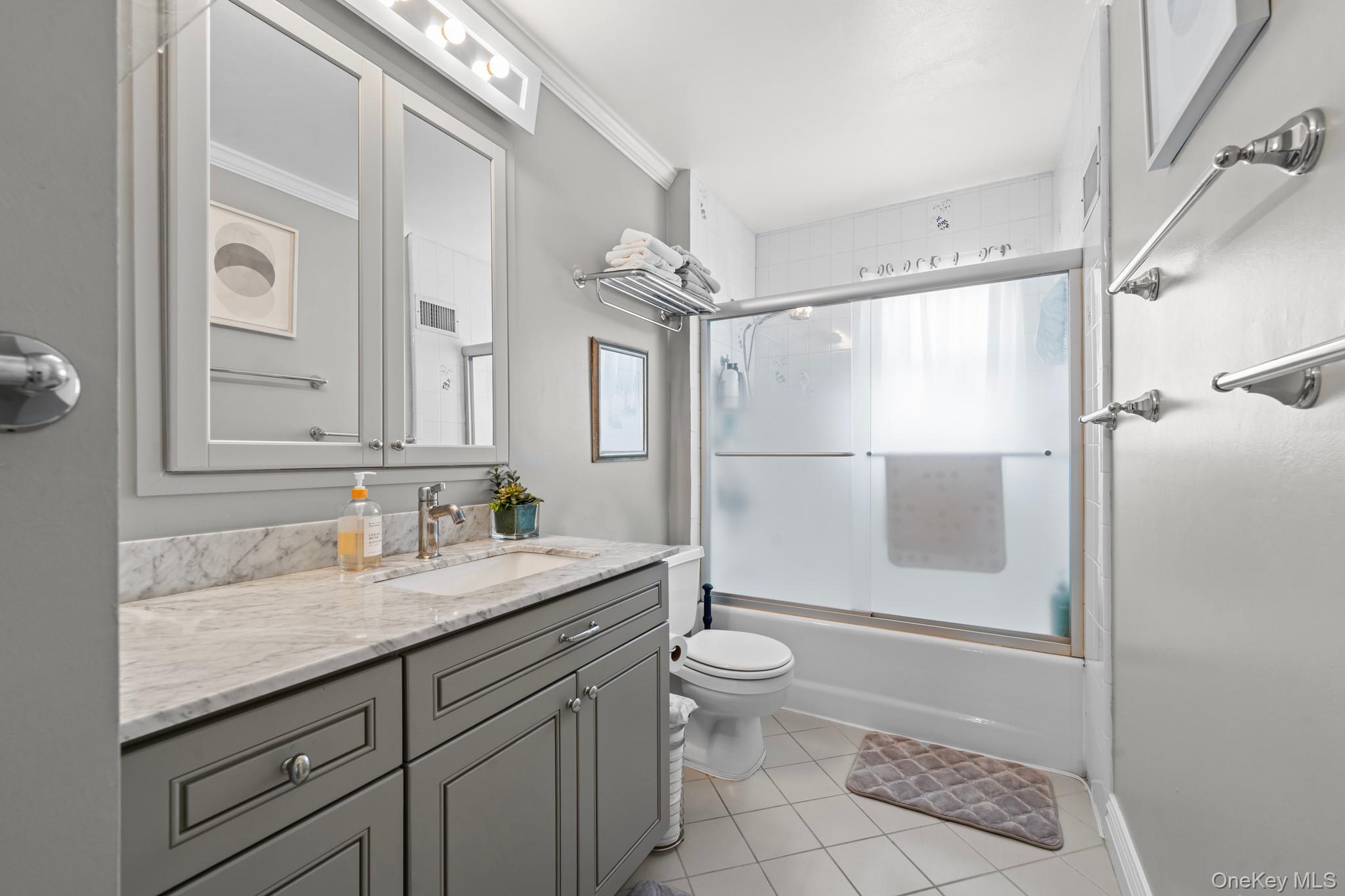 3530 Long Beach Road, Unit 44 Oceanside, NY 11572 - Photo 11 of 17 a bathroom with a granite countertop sink toilet and shower