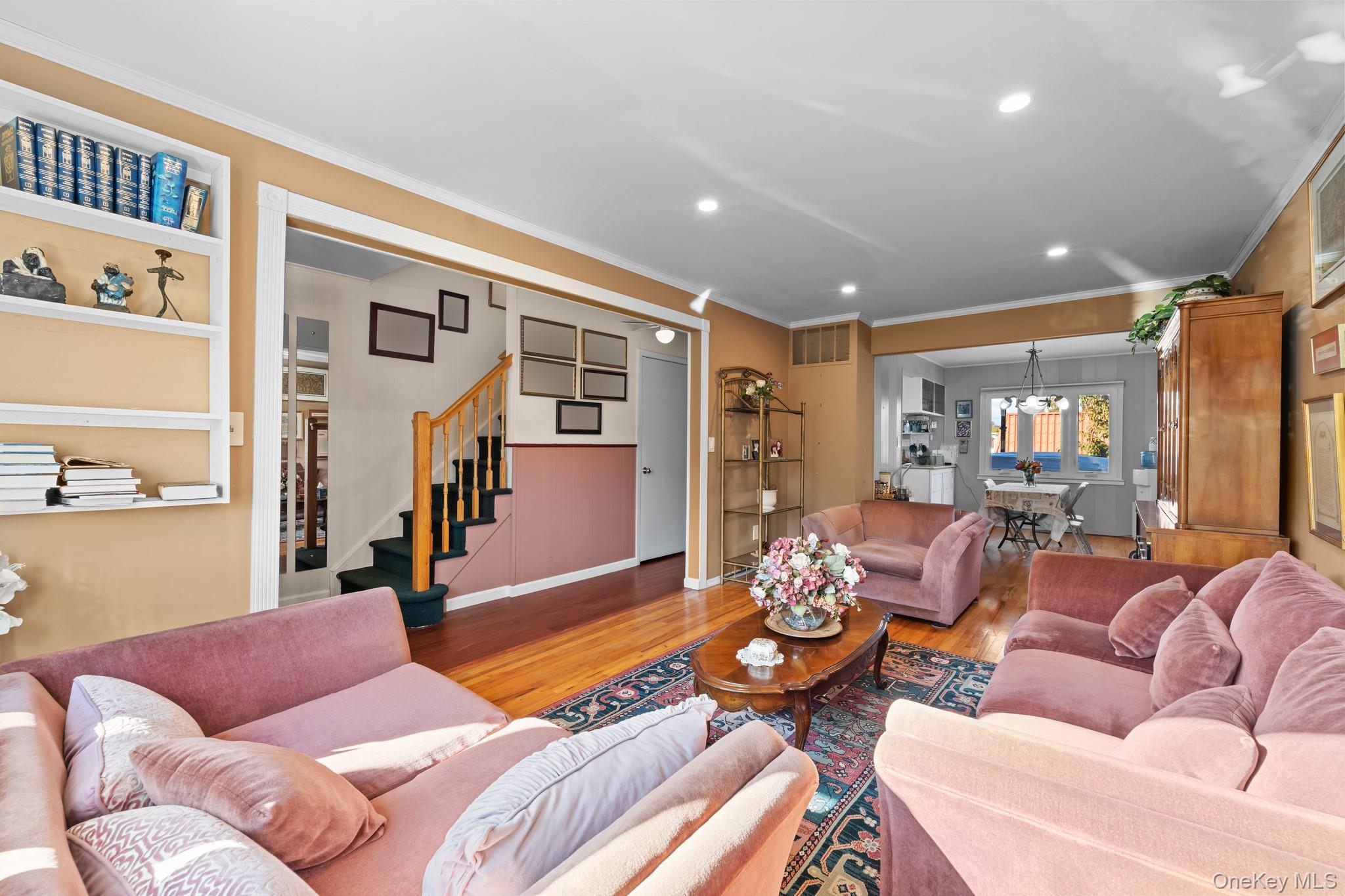 3530 Long Beach Road, Unit 44 Oceanside, NY 11572 - Photo 3 of 17 a living room with furniture kitchen view and a wooden floor