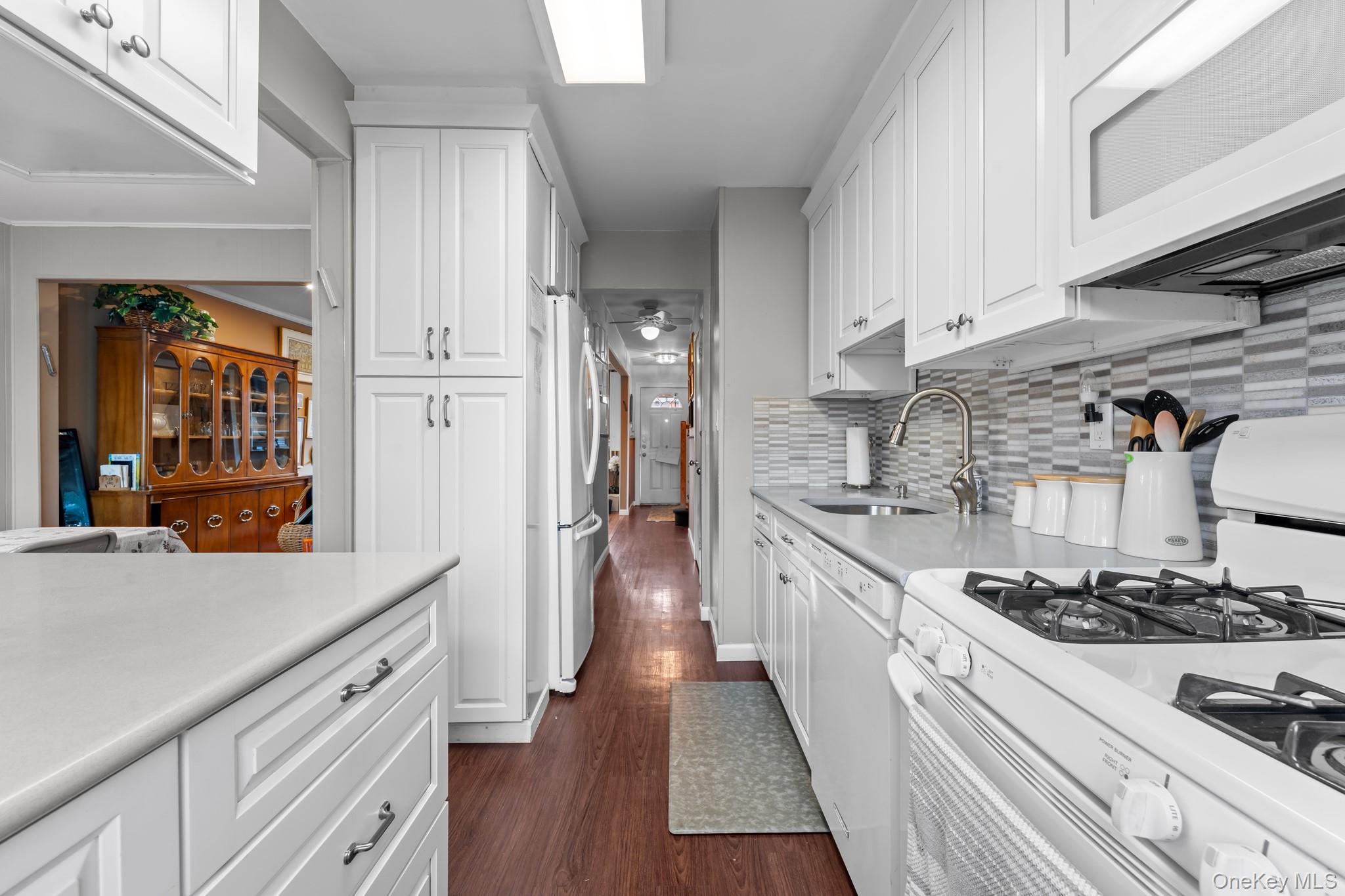 3530 Long Beach Road, Unit 44 Oceanside, NY 11572 - Photo 5 of 17 a kitchen with stainless steel appliances granite countertop a stove and a refrigerator
