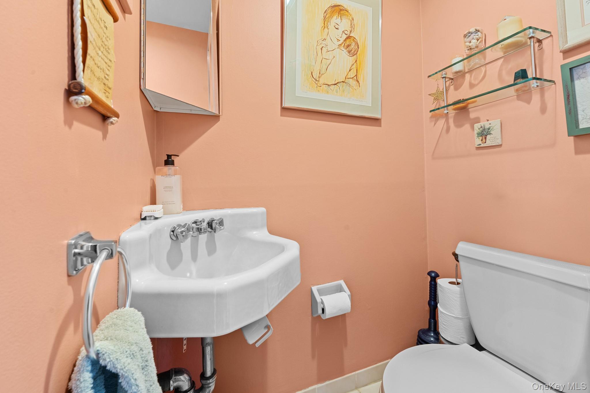 3530 Long Beach Road, Unit 44 Oceanside, NY 11572 - Photo 7 of 17 a bathroom with a toilet sink and mirror