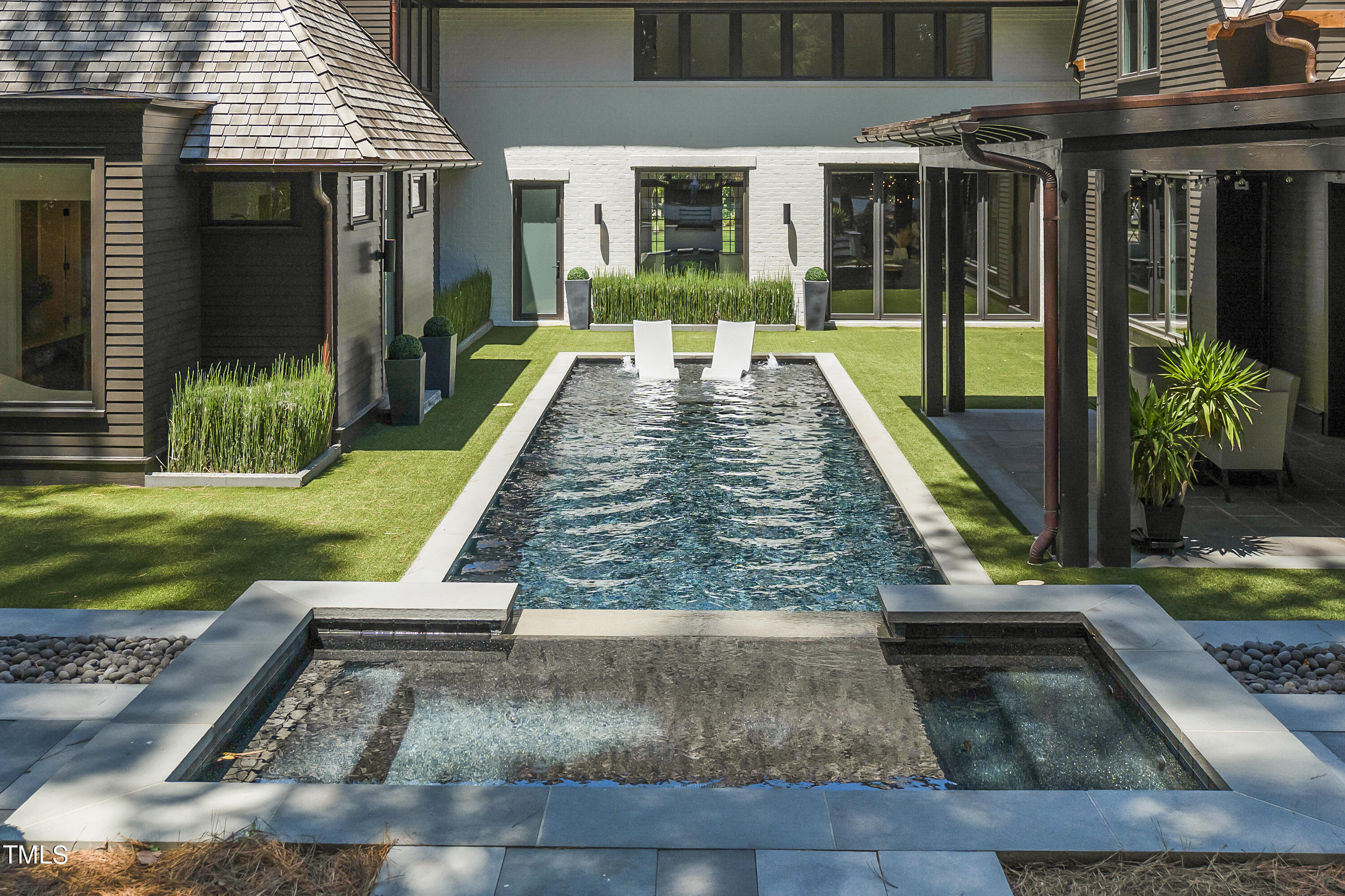 1722 Banbury Road Raleigh, NC 27608 - Photo 4 of 4 a view of a house with backyard porch and sitting area