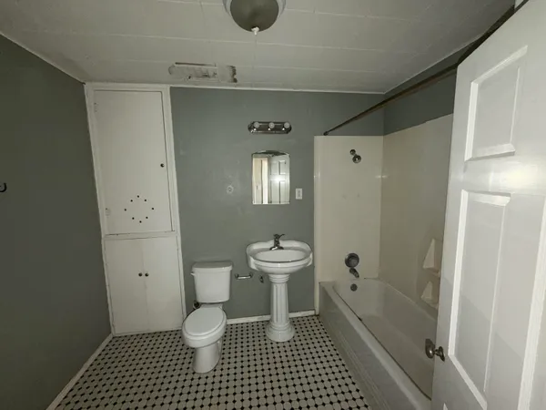 a bathroom with a toilet a sink and shower