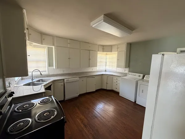 a kitchen with a stove a sink and a refrigerator