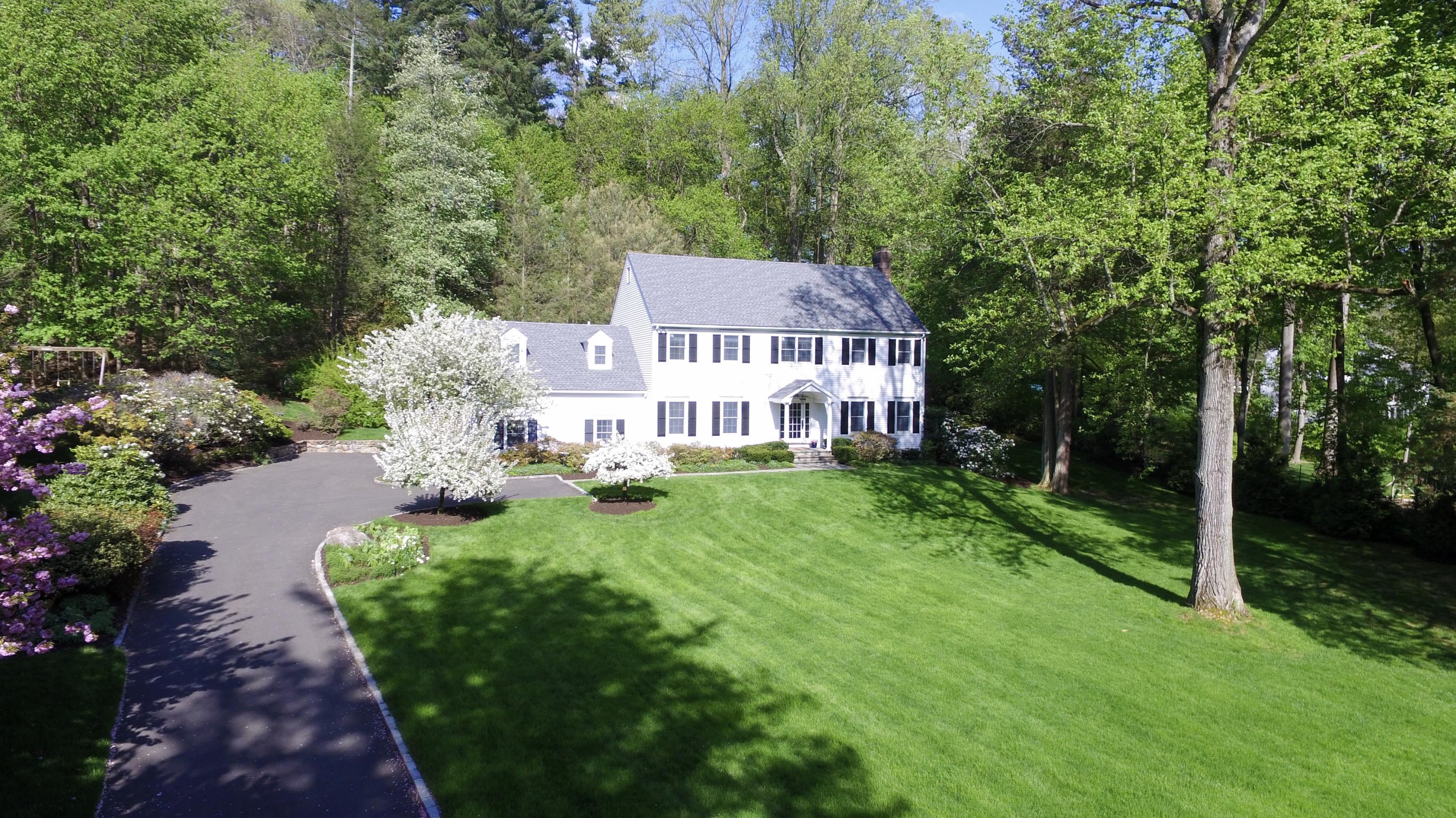 222 Marshall Ridge Road New Canaan, CT 06840 - Photo 2 of 49 a view of a house with a big yard and large trees