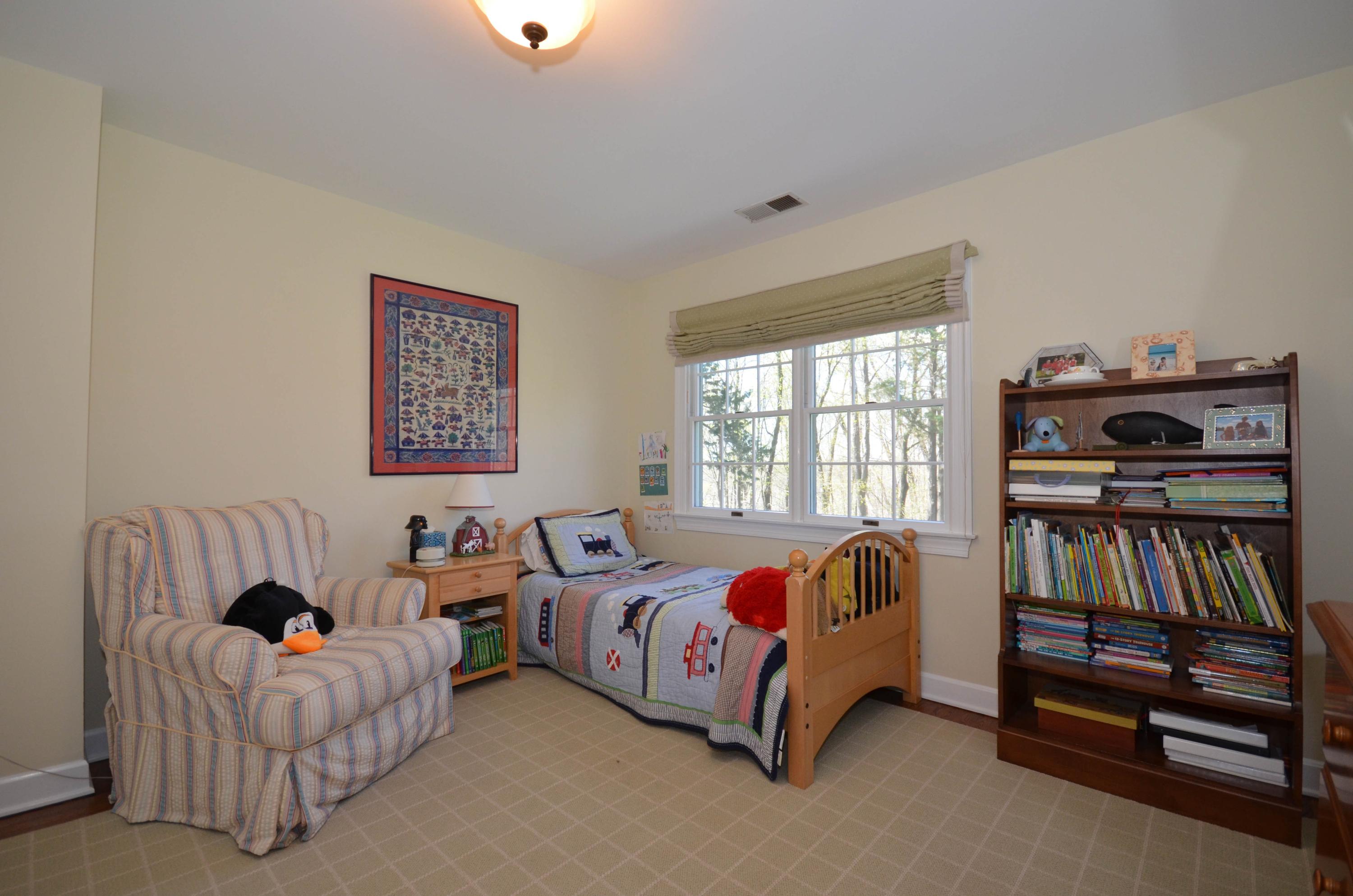 222 Marshall Ridge Road New Canaan, CT 06840 - Photo 33 of 49 a bedroom with bed and a book shelf