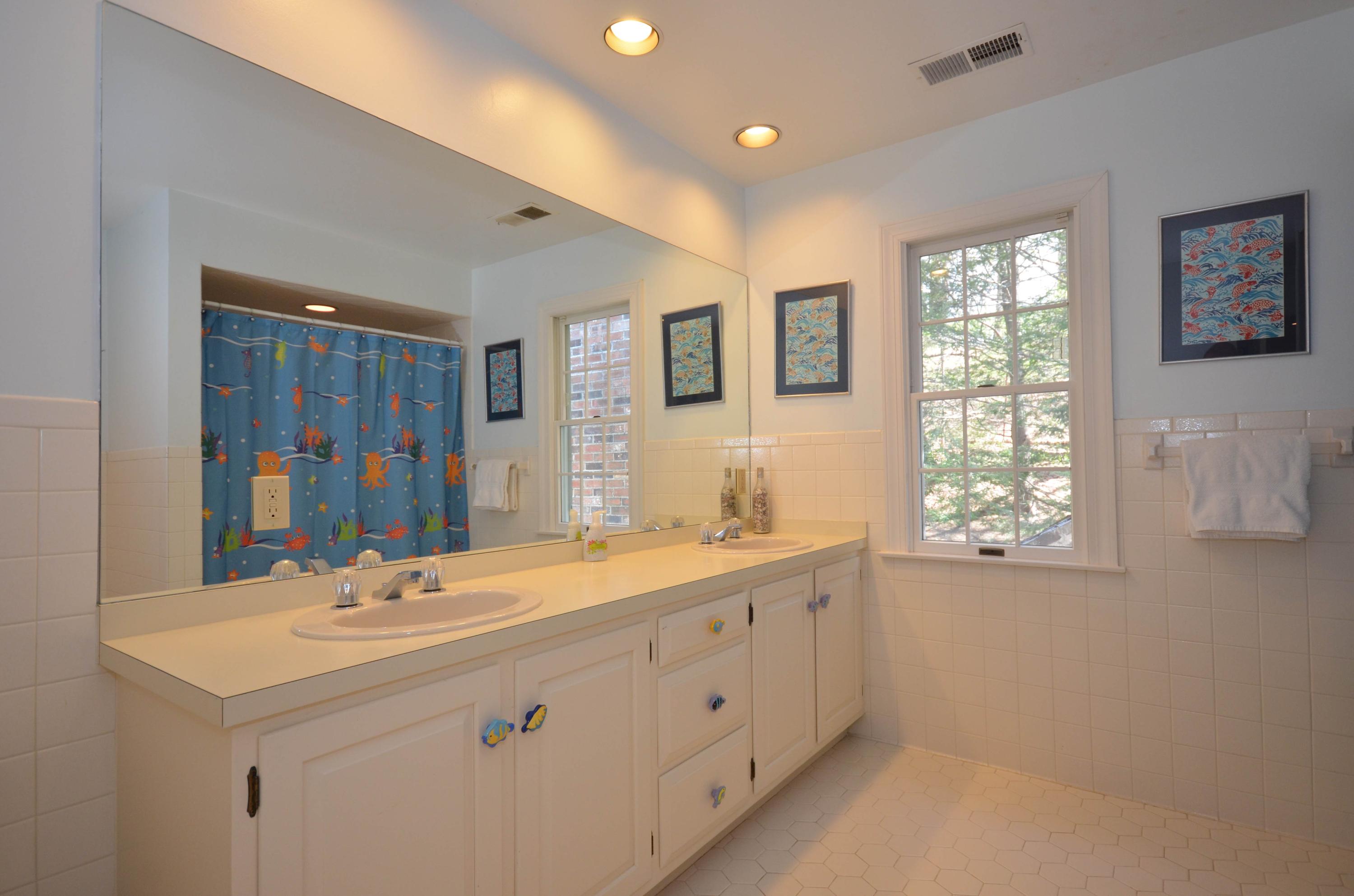222 Marshall Ridge Road New Canaan, CT 06840 - Photo 34 of 49 a bathroom with 2 sink tub and a mirror