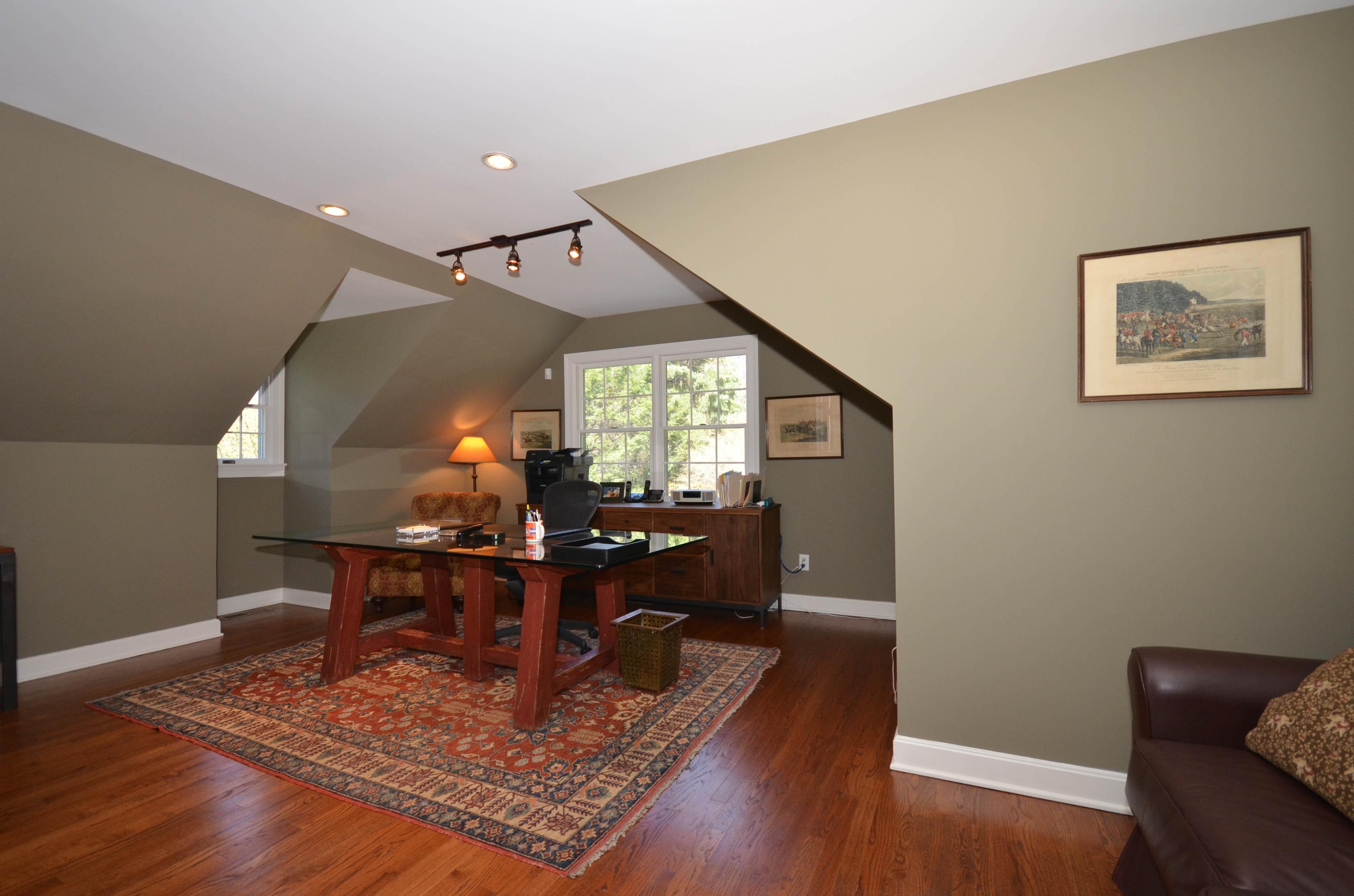 222 Marshall Ridge Road New Canaan, CT 06840 - Photo 37 of 49 a view of a workspace with furniture and wooden floor