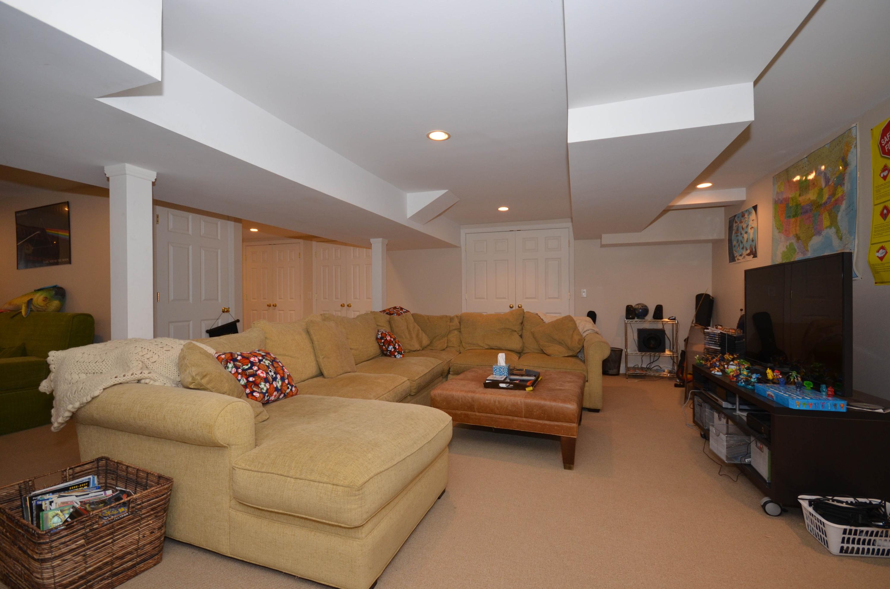 222 Marshall Ridge Road New Canaan, CT 06840 - Photo 39 of 49 a living room with furniture and a flat screen tv