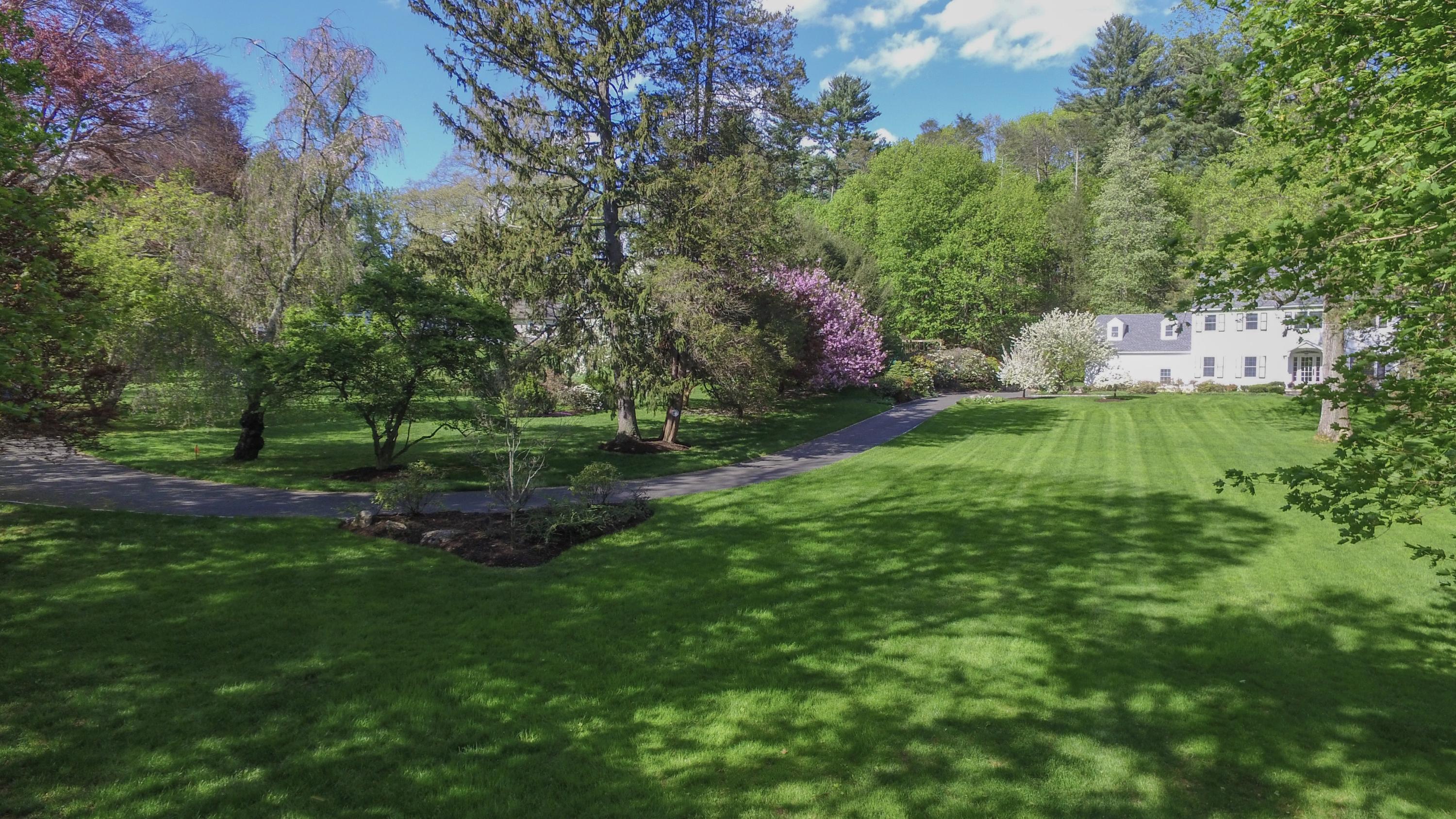 222 Marshall Ridge Road New Canaan, CT 06840 - Photo 44 of 49 a backyard of a house with lots of green space