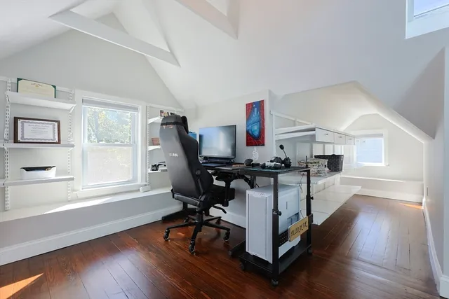 a view of a workspace with furniture and a window