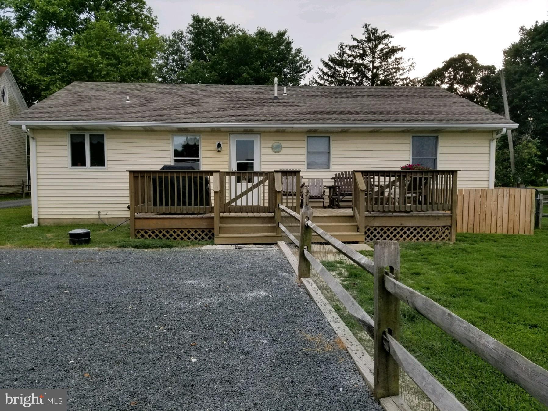 11629 Lynch Road Worton, MD 21678 - Photo 13 of 15 a view of a house with wooden deck and a yard