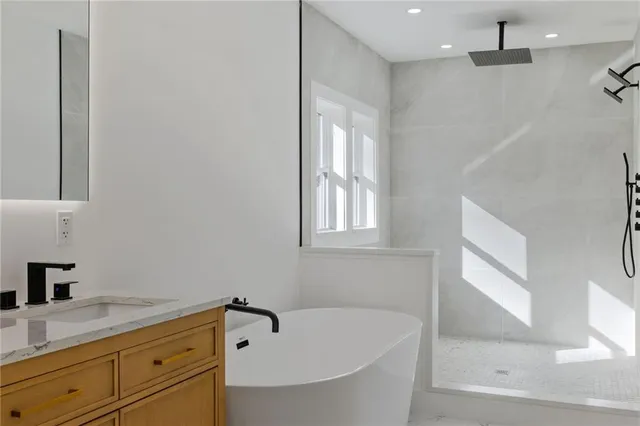 a bathroom with a bathtub and a sink