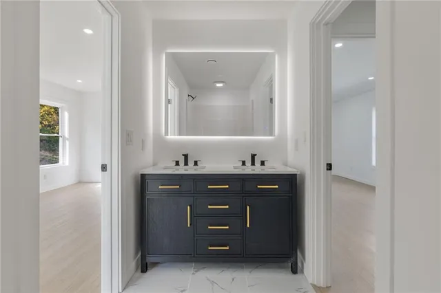 a bathroom with a sink vanity and mirror