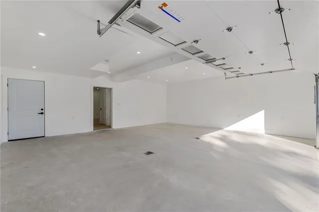 an empty room with ceiling fan and windows