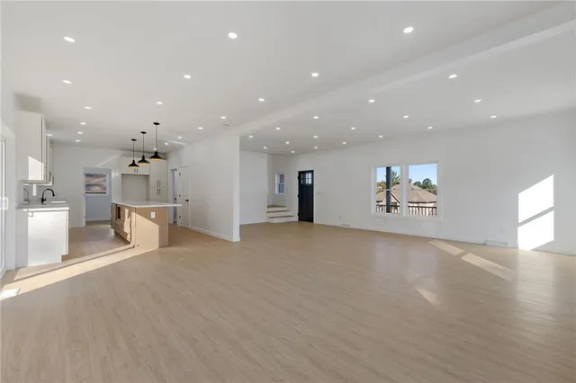 a view of a kitchen with a refrigerator and a living room