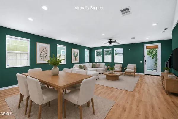 a view of a dining room with furniture window and wooden floor