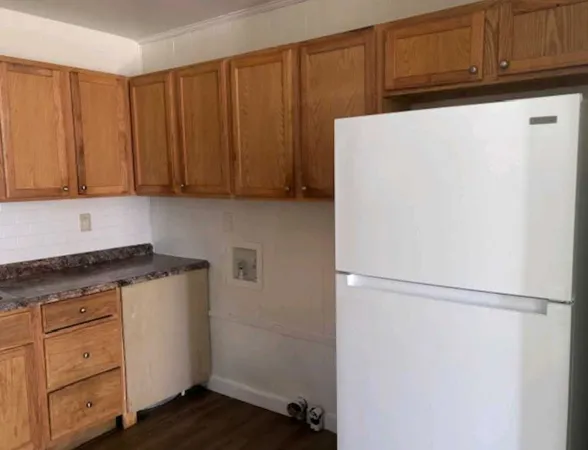 a white refrigerator freezer sitting inside of a kitchen