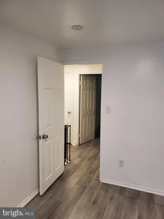 an empty room with wooden floor and closet