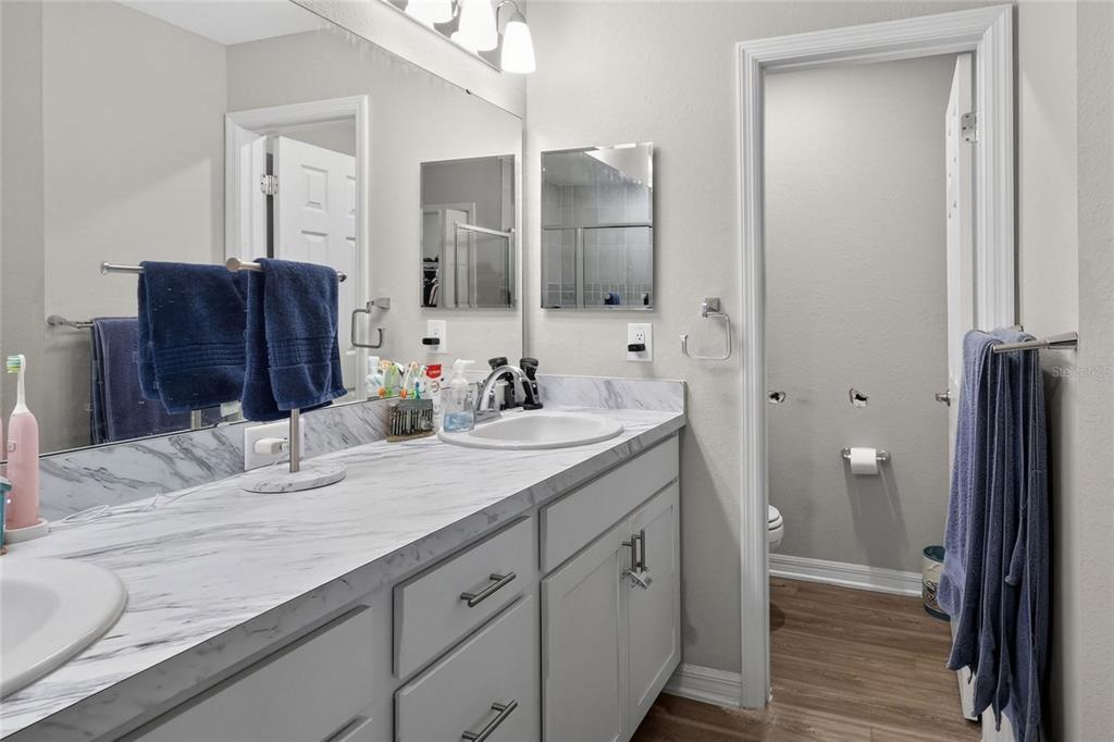 6360 Gardner Road Lakeland, FL 33813 - Photo 29 of 47 a bathroom with a granite countertop double vanity sink mirror and shower