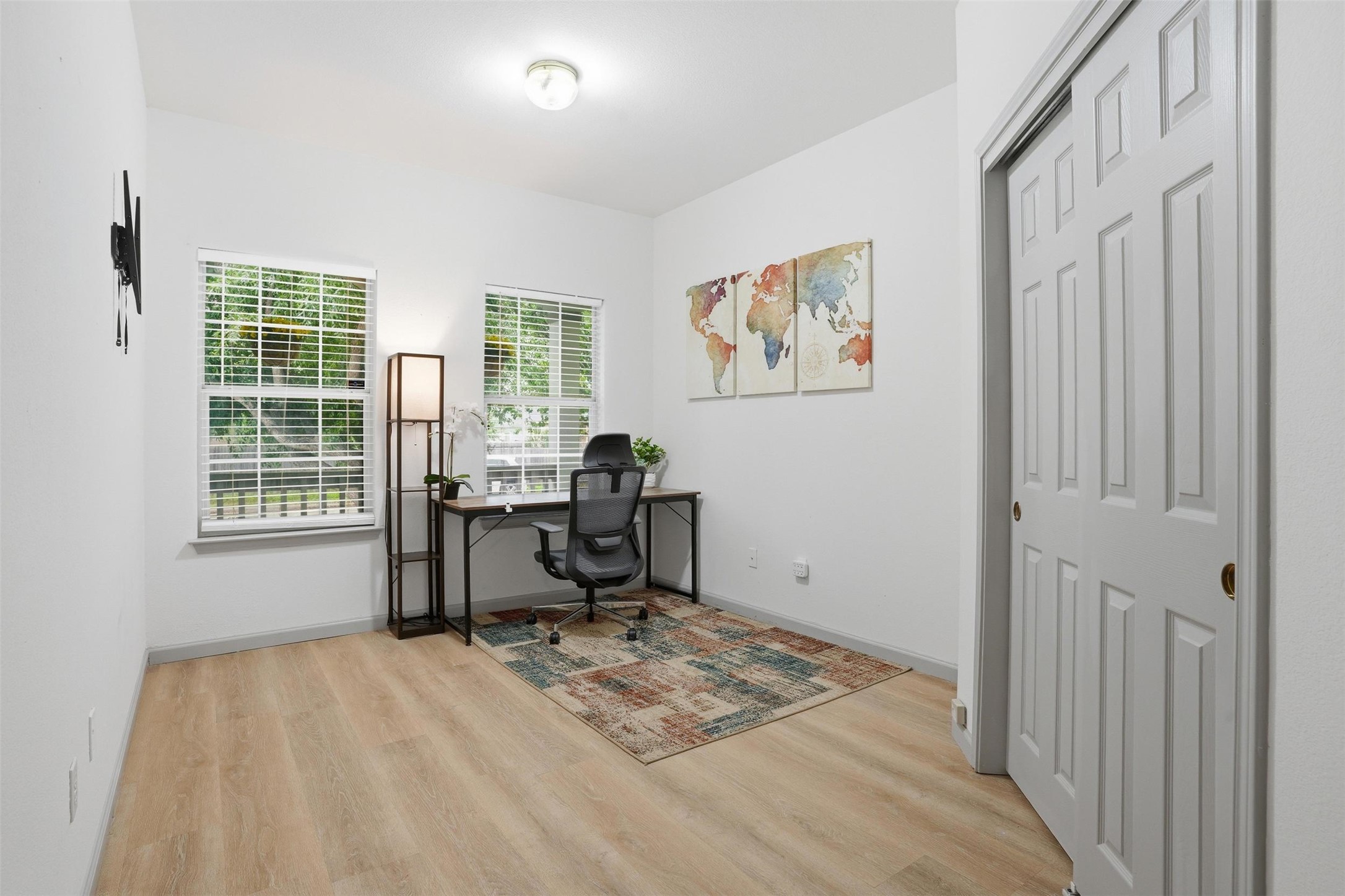 11606 Murchison Street Manor, TX 78653 - Photo 24 of 35 Bright bedroom featuring light-toned flooring, two windows with blinds. This room is currently used as an office.