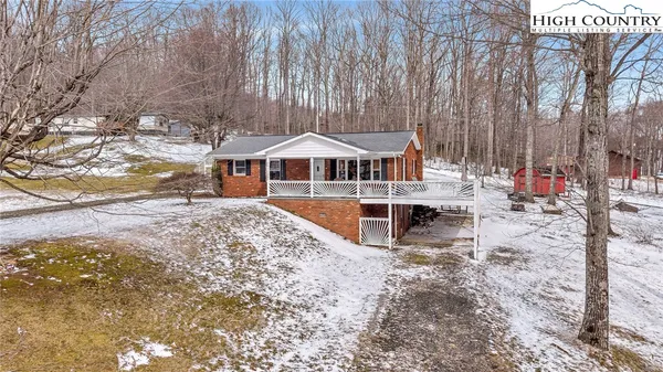 a view of a house with a yard covered in snow