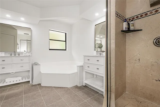 a bathroom with a bathtub shower and a sink