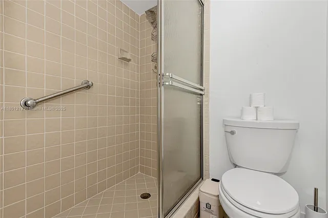 a white toilet sitting next to a bathroom sink