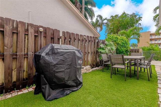 a view of backyard with a fireplace and furniture