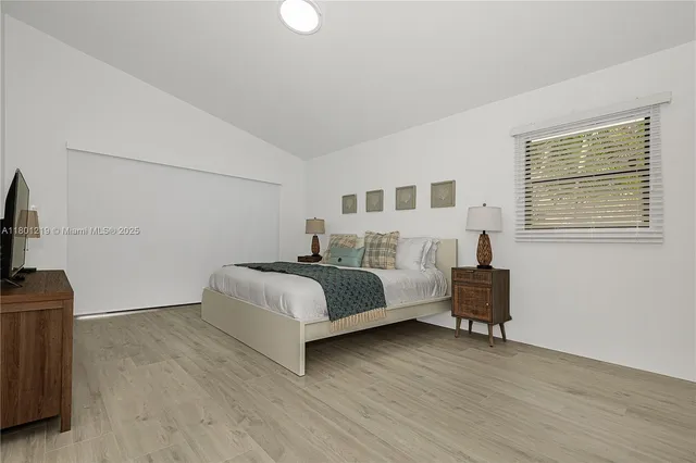 a bedroom with a bed and a flat screen tv