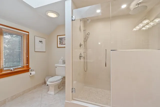a bathroom with a toilet a sink and shower