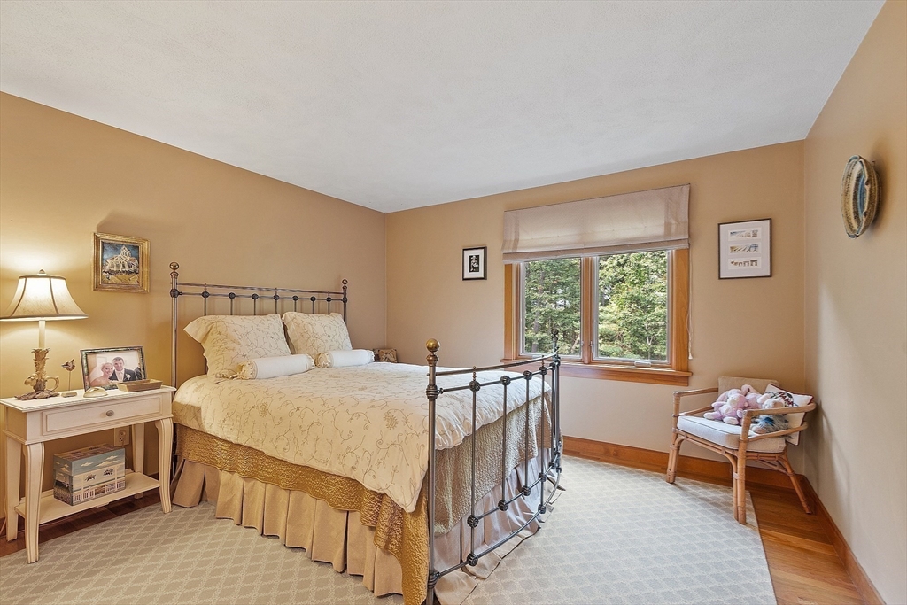 132 Williams Road Concord, MA 01742 - Photo 25 of 38 a bedroom with a bed and a table in it