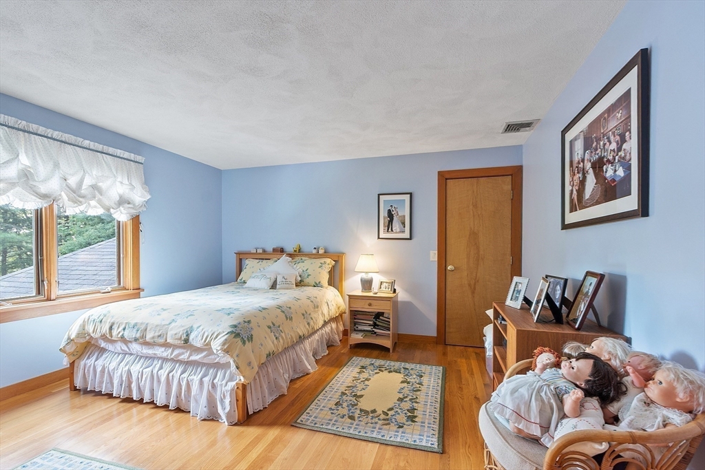 132 Williams Road Concord, MA 01742 - Photo 26 of 38 a bedroom with a bed and wooden floor