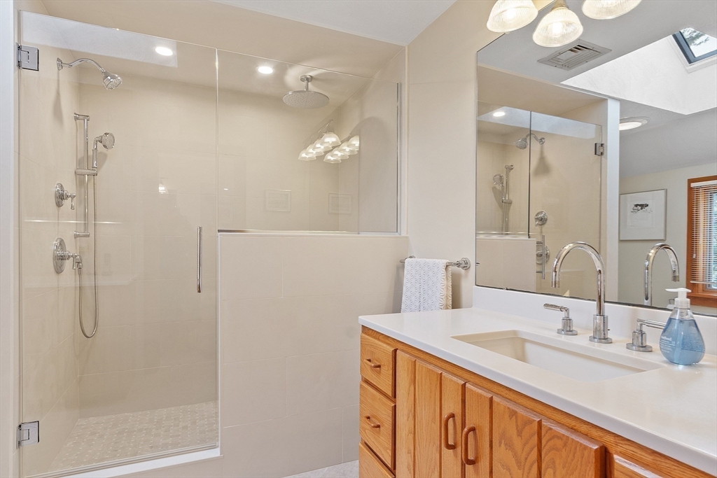 132 Williams Road Concord, MA 01742 - Photo 31 of 38 a bathroom with a double vanity sink mirror and shower