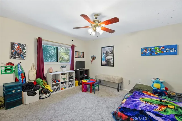 a living room with furniture a flat screen tv and a window