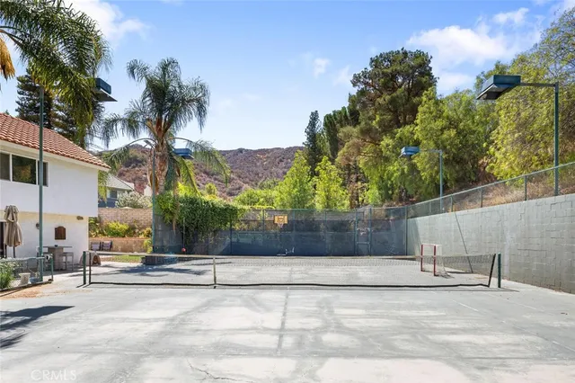 a view of a house with backyard water fountain and sitting area