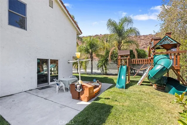 a view of an house with swimming pool and sitting area