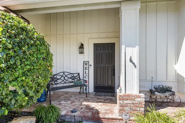 a view of an entryway with flower pots