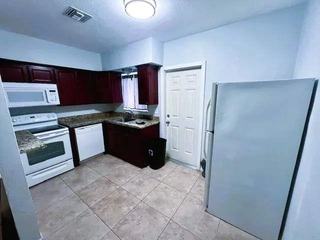 a kitchen with stainless steel appliances a stove a refrigerator and a sink