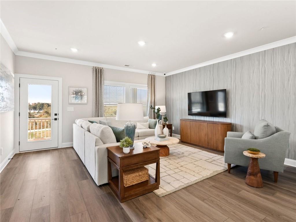 6410 Pinin Place Cumming, GA 30041 - Photo 5 of 11 a living room with furniture and a flat screen tv