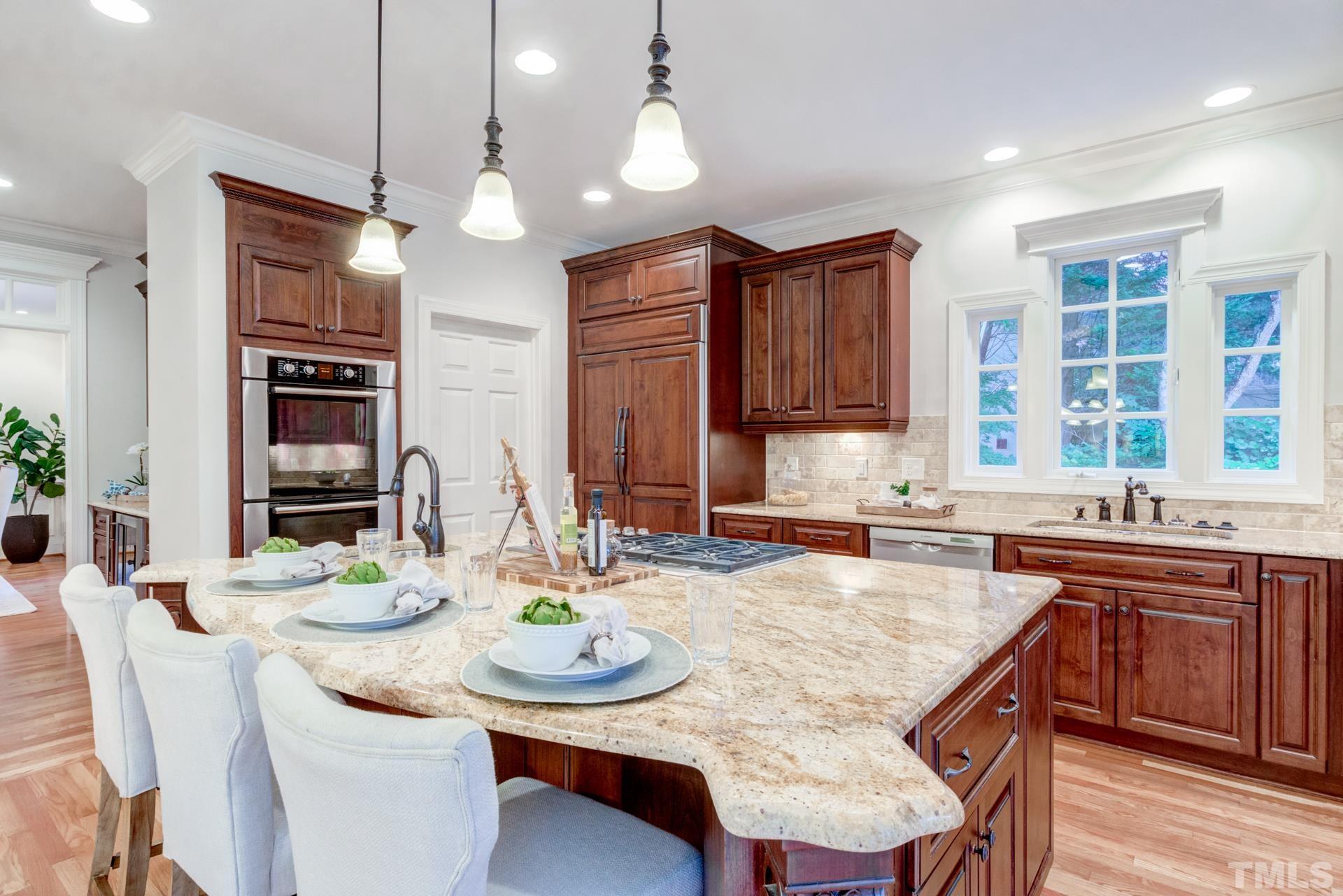 109 Ronsard Lane Cary, NC 27511 - Photo 11 of 26 a kitchen with granite countertop a sink and stove