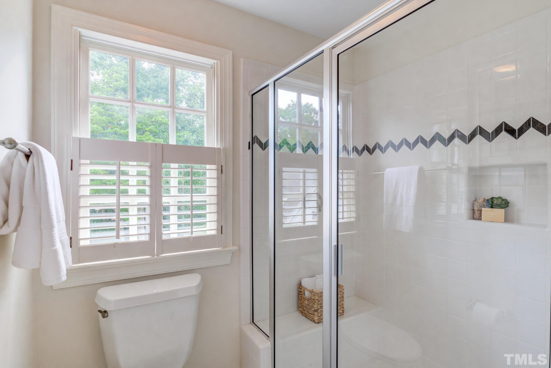 109 Ronsard Lane Cary, NC 27511 - Photo 19 of 26 a bathroom with a shower and a window